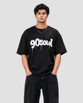 A man wearing a black crewneck t-shirt with a white '90soul' graphic printed across the chest, paired with black jeans, against a light gray studio background.