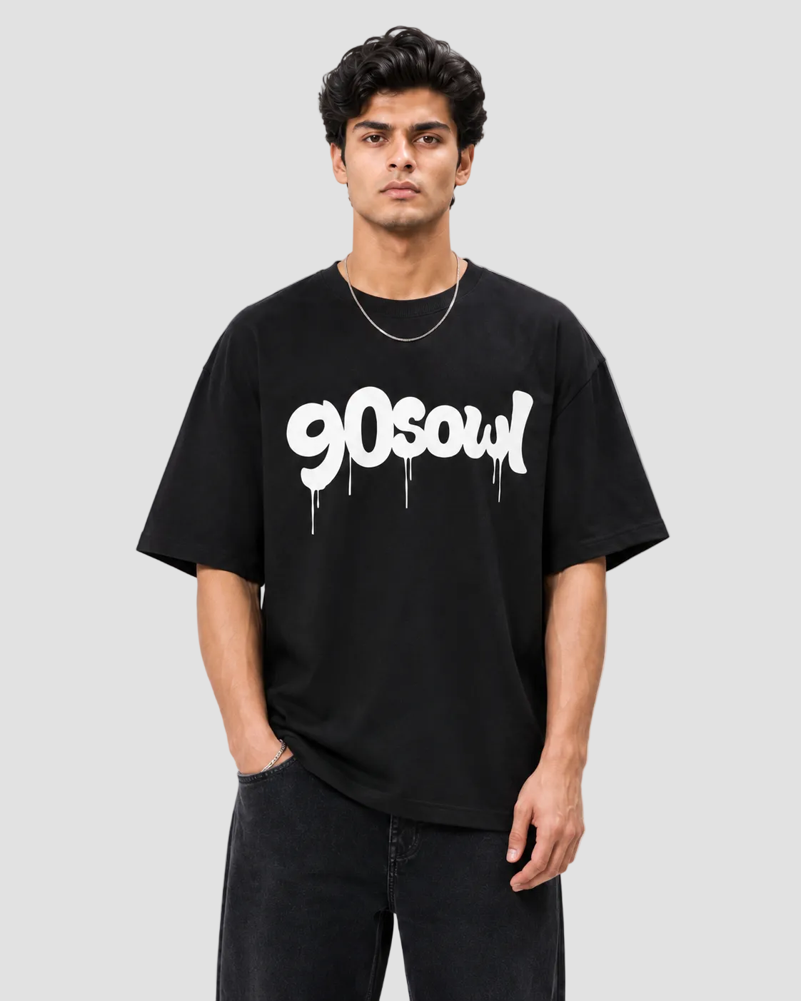 A man wearing a black t-shirt with a white '90soul' graphic, standing against a light gray background.