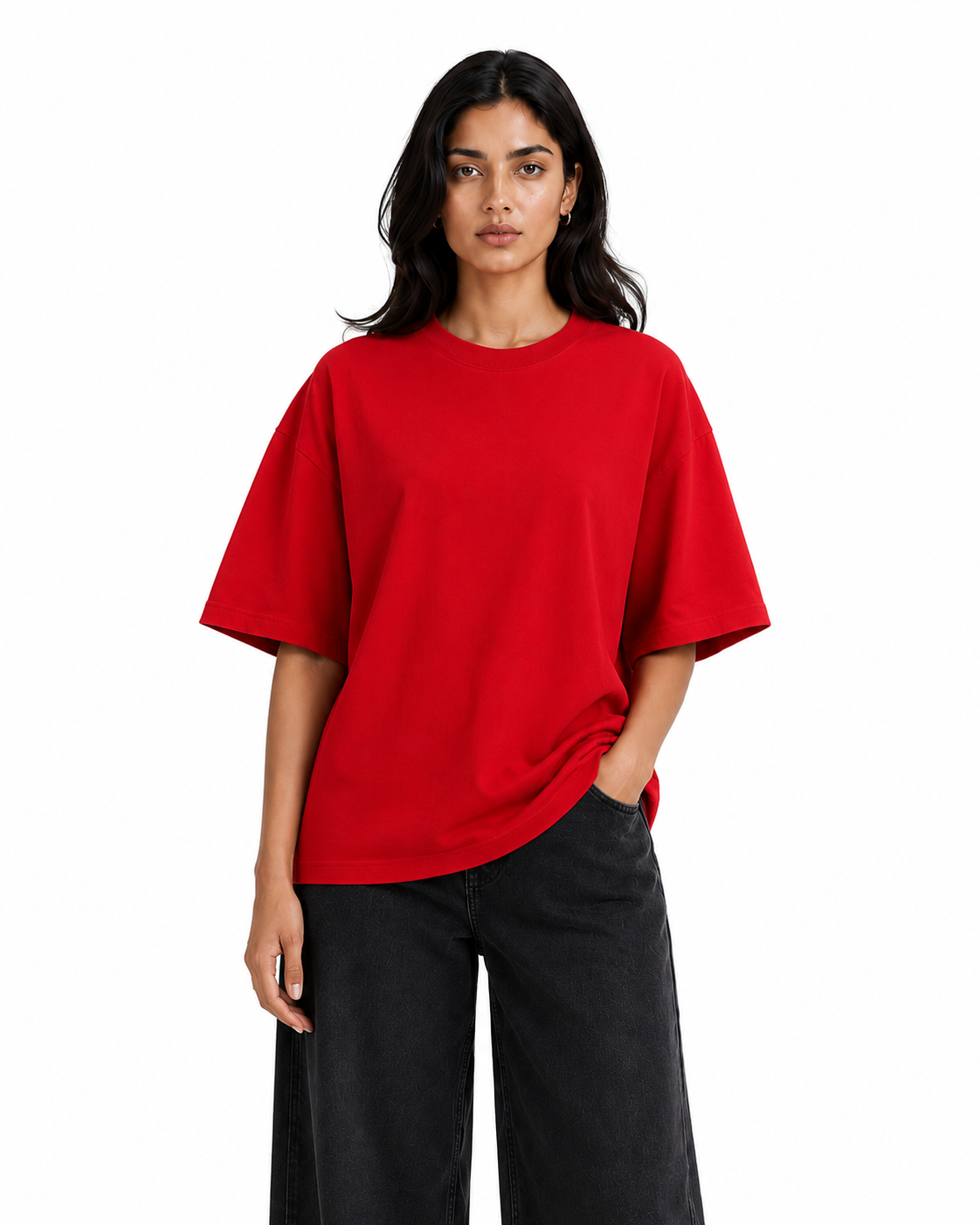 A woman modeling an oversized bright red short-sleeve crewneck t-shirt paired with black wide-leg pants, shot against a solid white background.