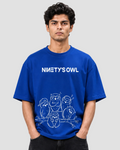 A man wearing a royal blue t-shirt with a white graphic print that reads 'NINETY'S OWL' above a line drawing of five owls, photographed against a light gray studio background.