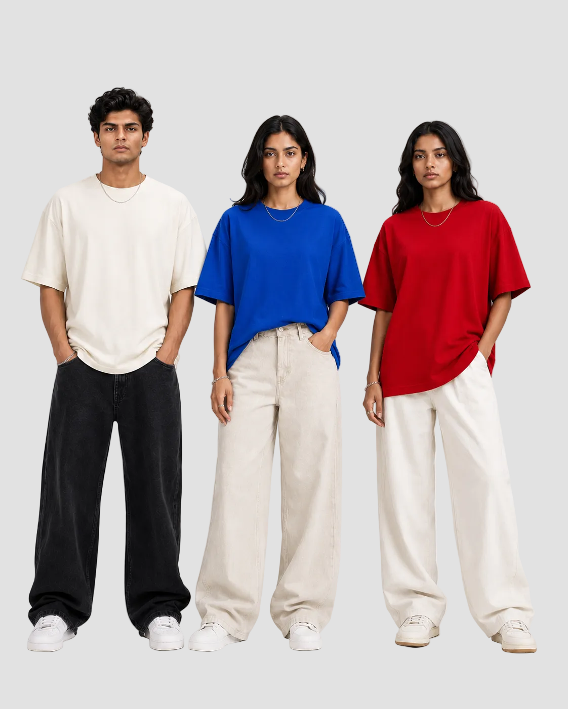 Three models standing side by side wearing oversized short-sleeve t-shirts in off-white, royal blue, and red, paired with wide-leg cream pants and white sneakers against a light gray studio background.