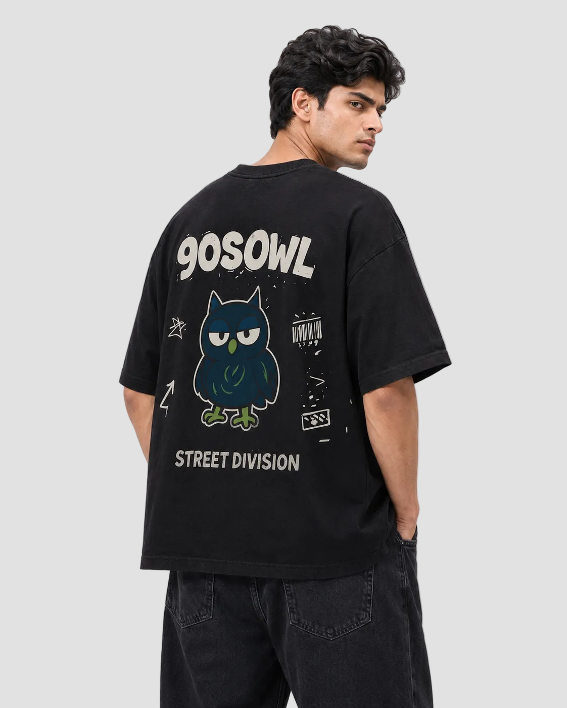 A man wearing a black oversized t-shirt from the back, featuring a graphic of a blue owl with white text that reads '90SOWL' and 'STREET DIVISION'.