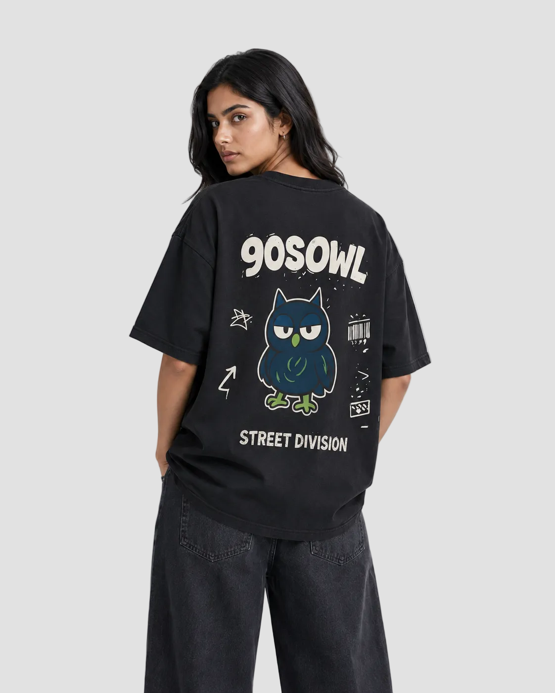 A woman modeling a black oversized t-shirt from the back, featuring a graphic of a blue owl with green eyes and the text '90SOWL' and 'STREET DIVISION'.